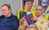 Master Kumar presents the book "Spiritual Astrology Paintings" during the Guru Puja celebration 2020, Visakhapatnam, India