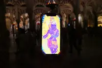"Krishna at the Mezquita-Catedral" Cordoba, Spain. Display of the mobile of a friend, May 2024. Several people use the "Images of Synthesis" on their mobiles.